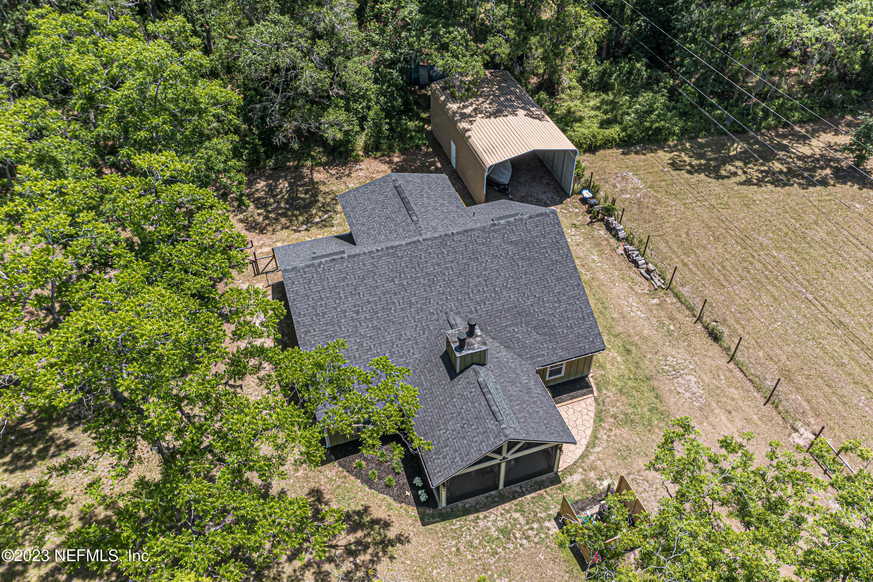 1199 Hatcher Road Middleburg, FL 32068 - Photo 51 of 55 an aerial view of a house with yard and trees in the back
