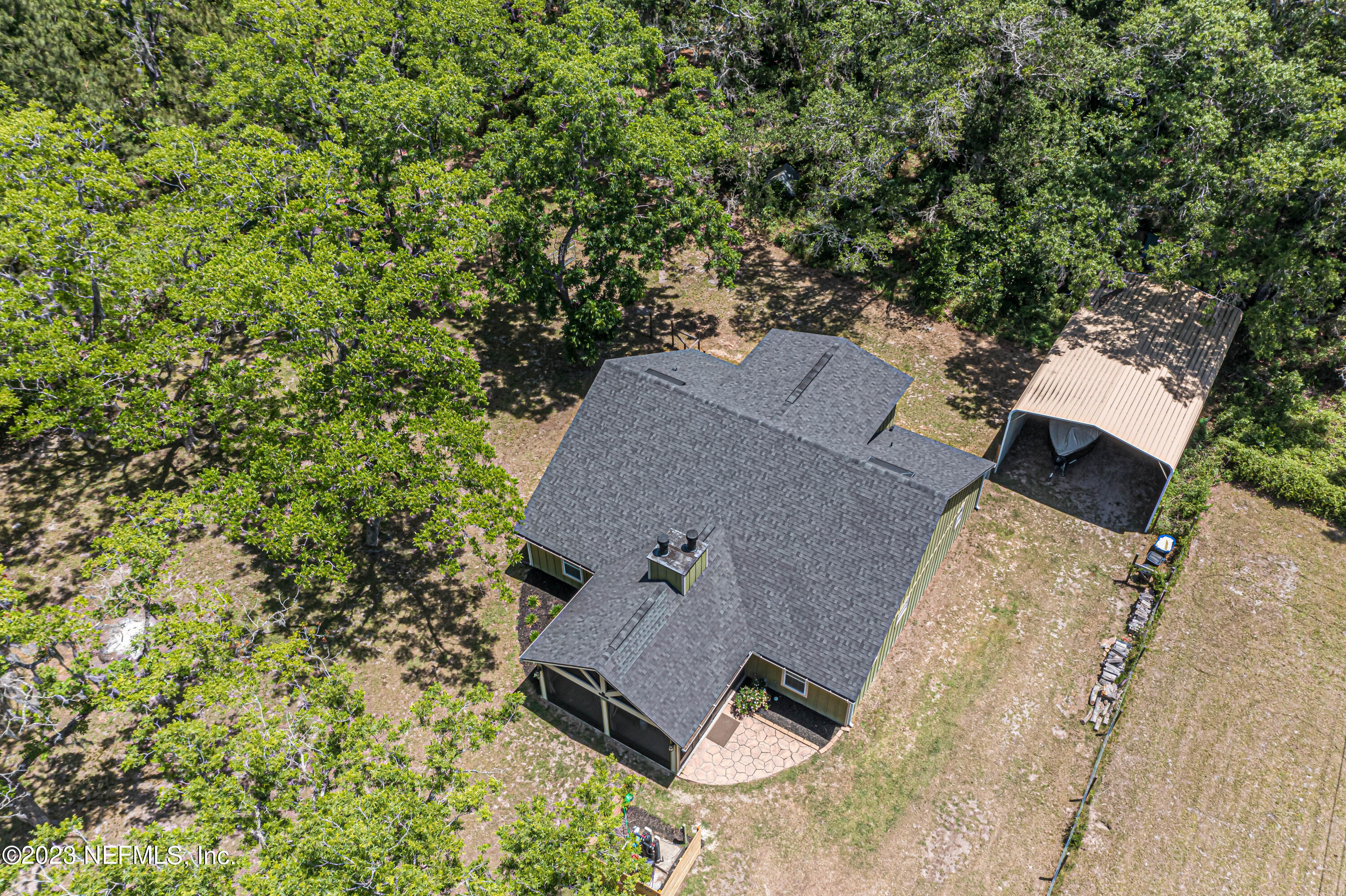 1199 Hatcher Road Middleburg, FL 32068 - Photo 52 of 55 an aerial view of a house with yard and trees in the background