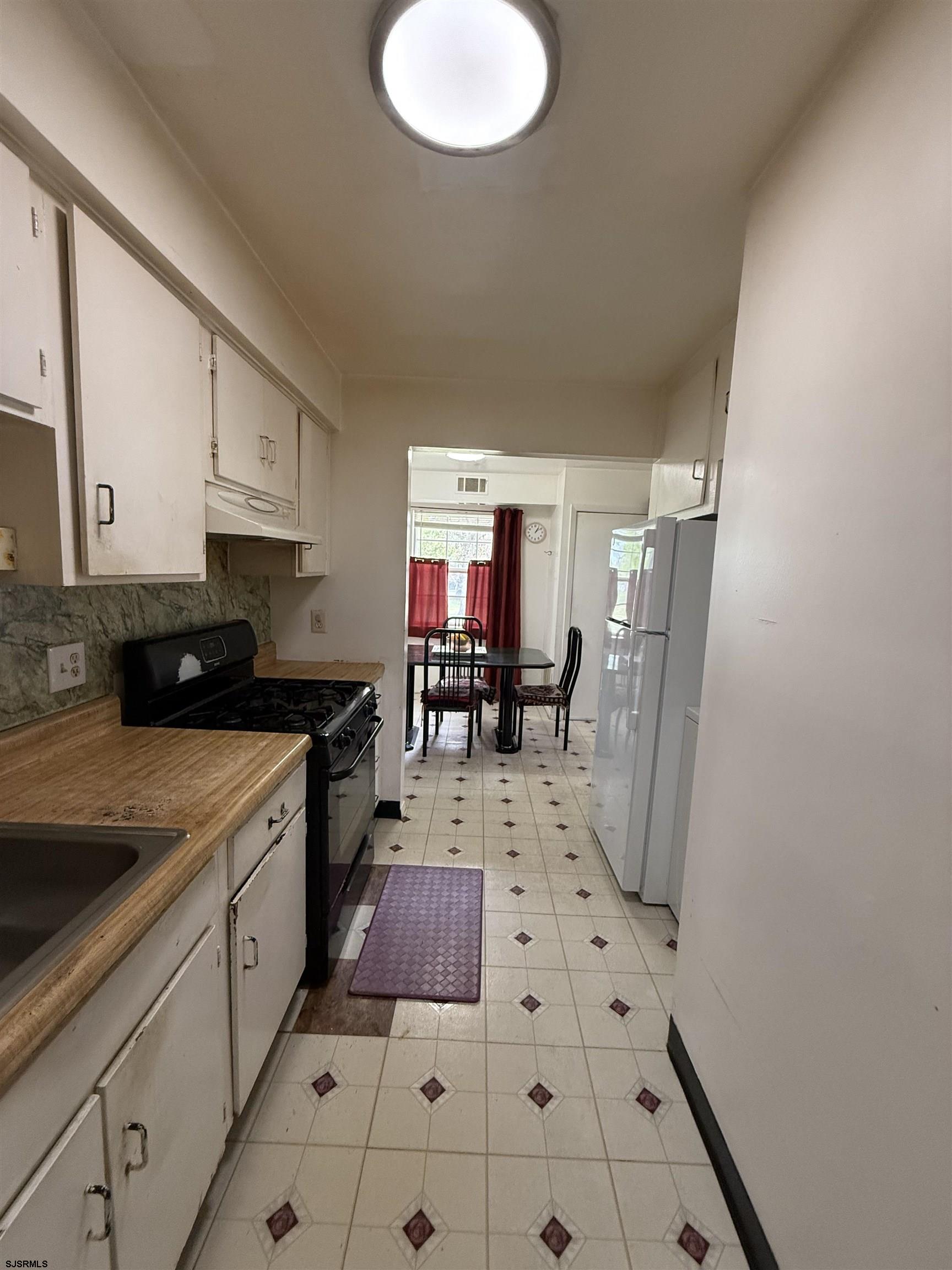 720 South New Road, Unit 3L Absecon, NJ 08201 - Photo 12 of 25 a very nice looking open kitchen with stainless steel appliances granite countertop a refrigerator and a stove top oven