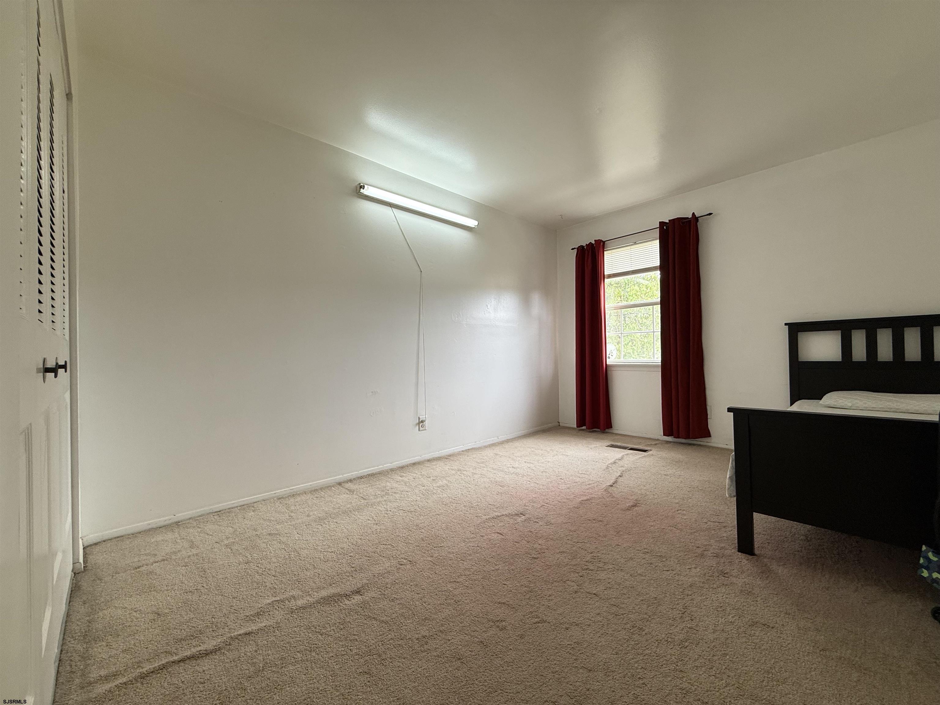 720 South New Road, Unit 3L Absecon, NJ 08201 - Photo 20 of 25 an empty room with windows and ceiling fan
