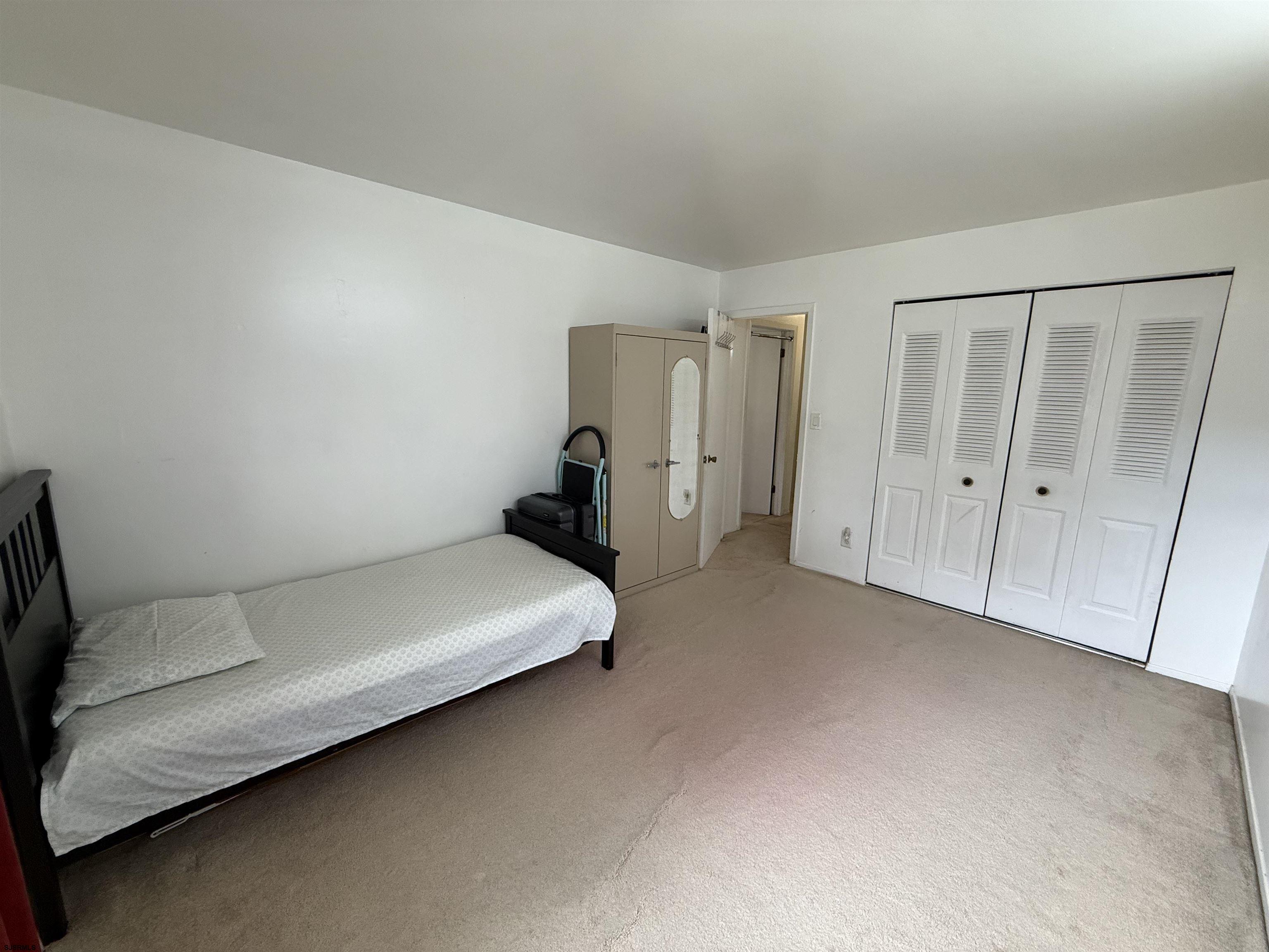 720 South New Road, Unit 3L Absecon, NJ 08201 - Photo 21 of 25 a spacious bedroom with a bed and a cabinet
