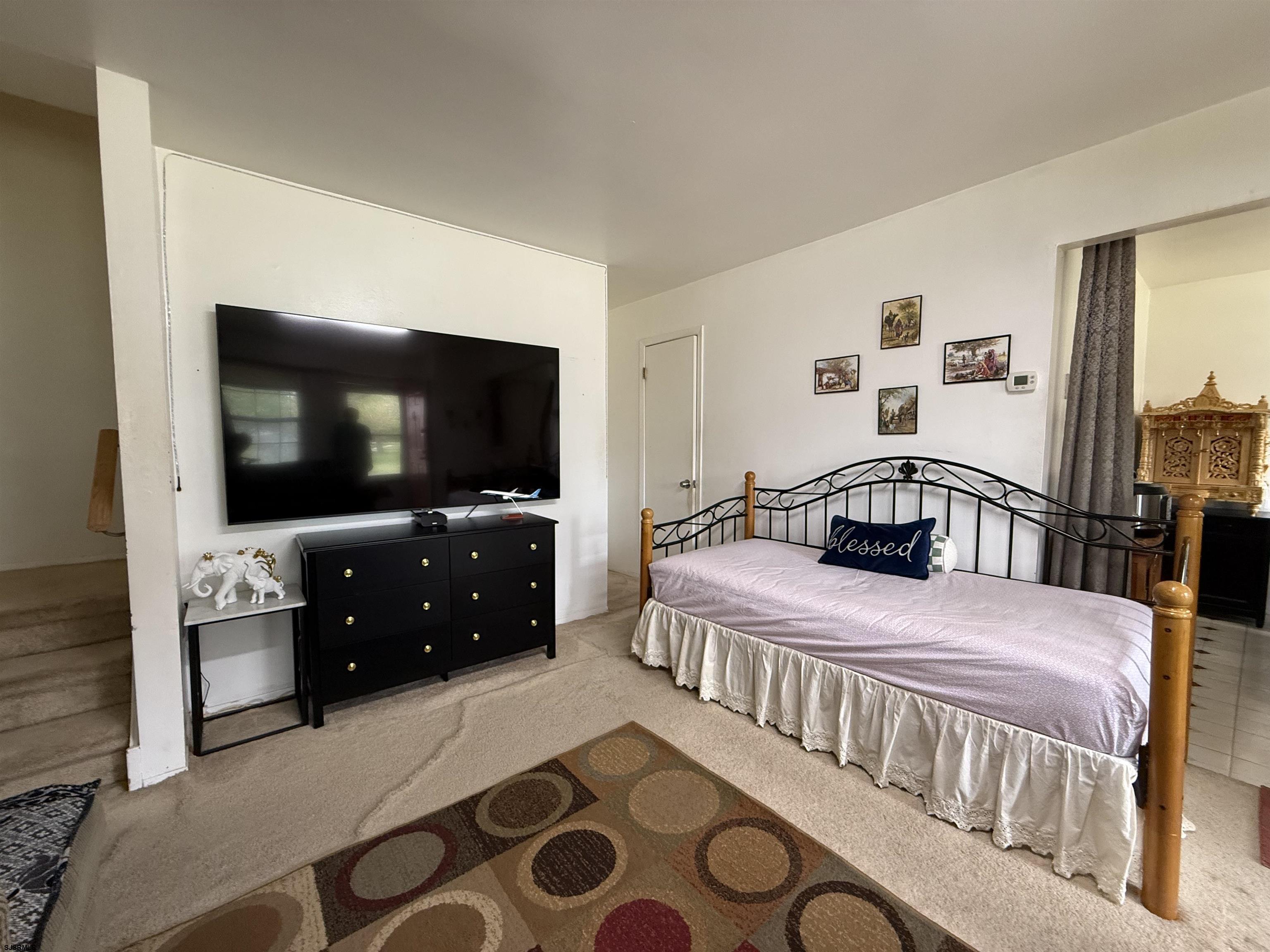 720 South New Road, Unit 3L Absecon, NJ 08201 - Photo 4 of 25 a bedroom with a bed and a flat tv screen on dresser