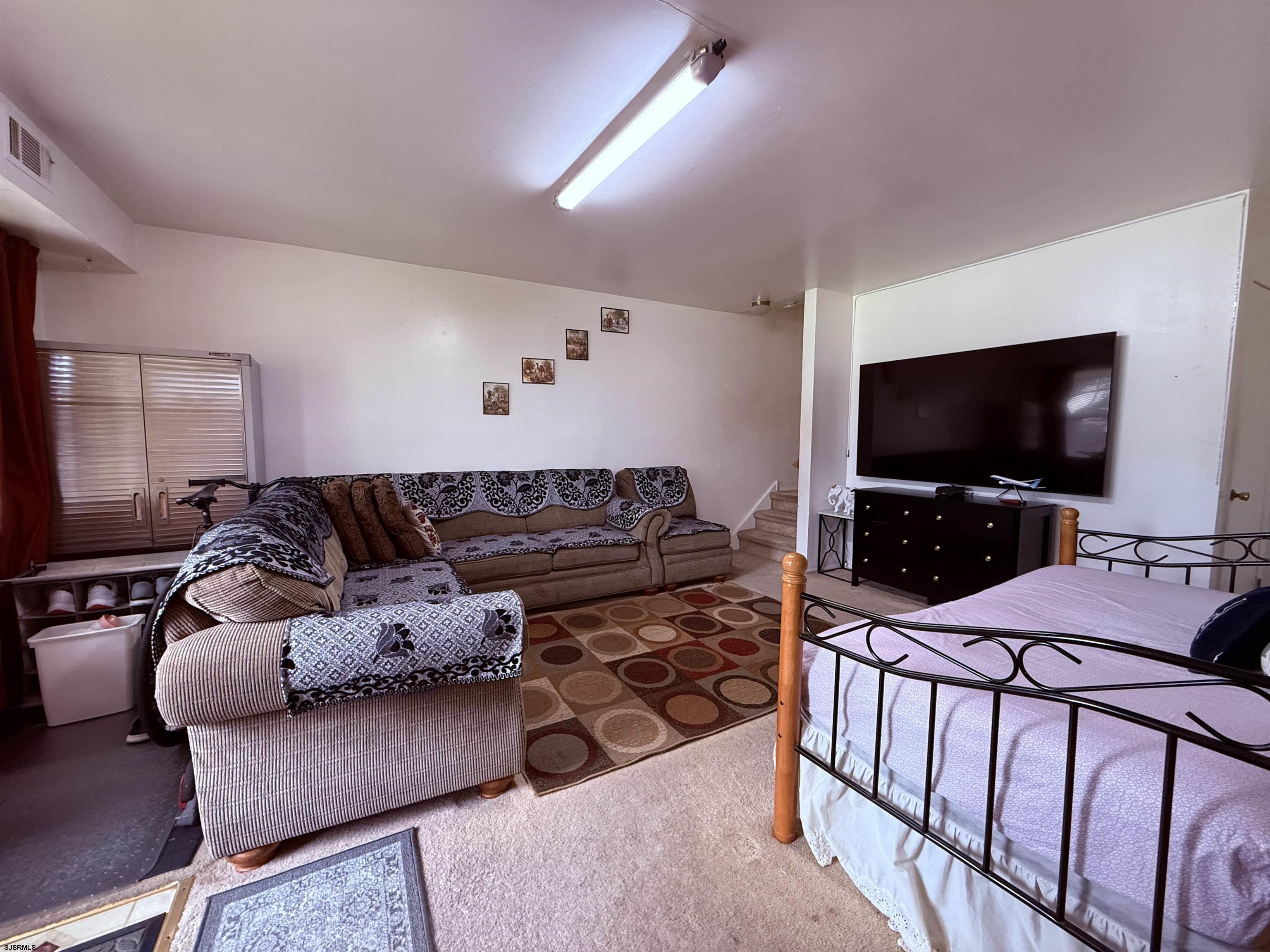 720 South New Road, Unit 3L Absecon, NJ 08201 - Photo 6 of 25 a living room with furniture and a flat screen tv