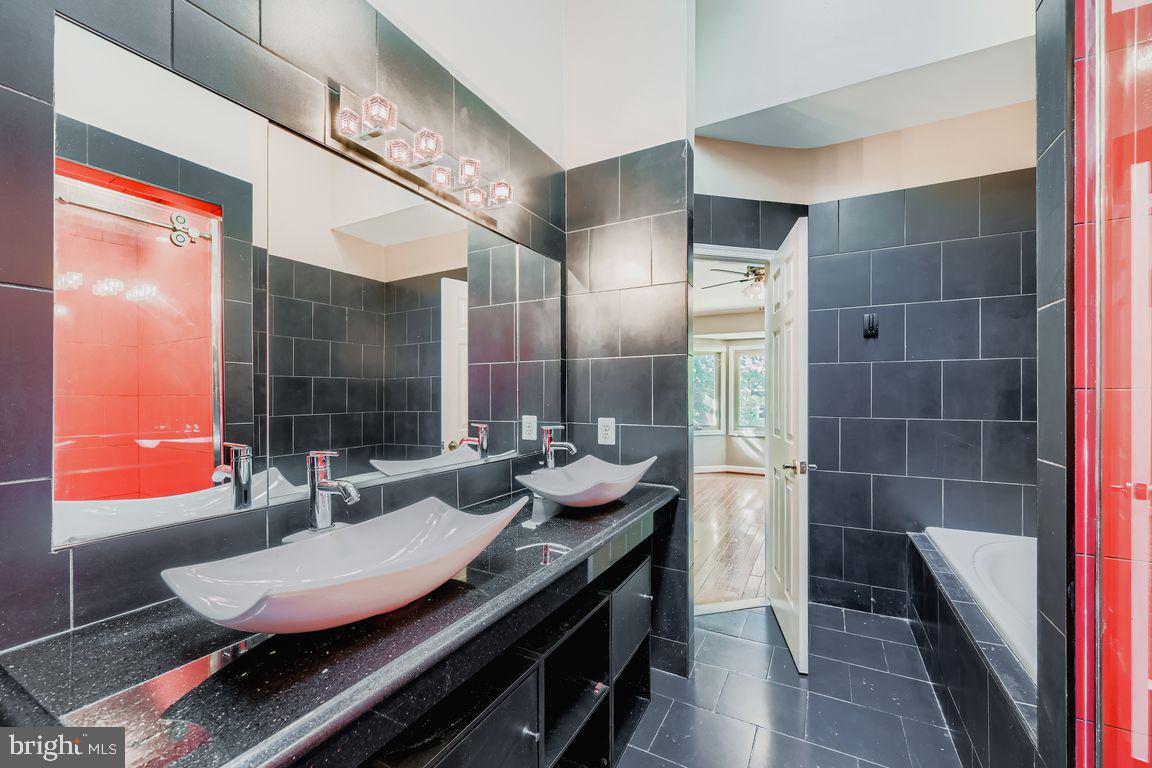 21 Stridesham Court Baltimore, MD 21209 - Photo 12 of 22 a bathroom with a double vanity sink and a mirror