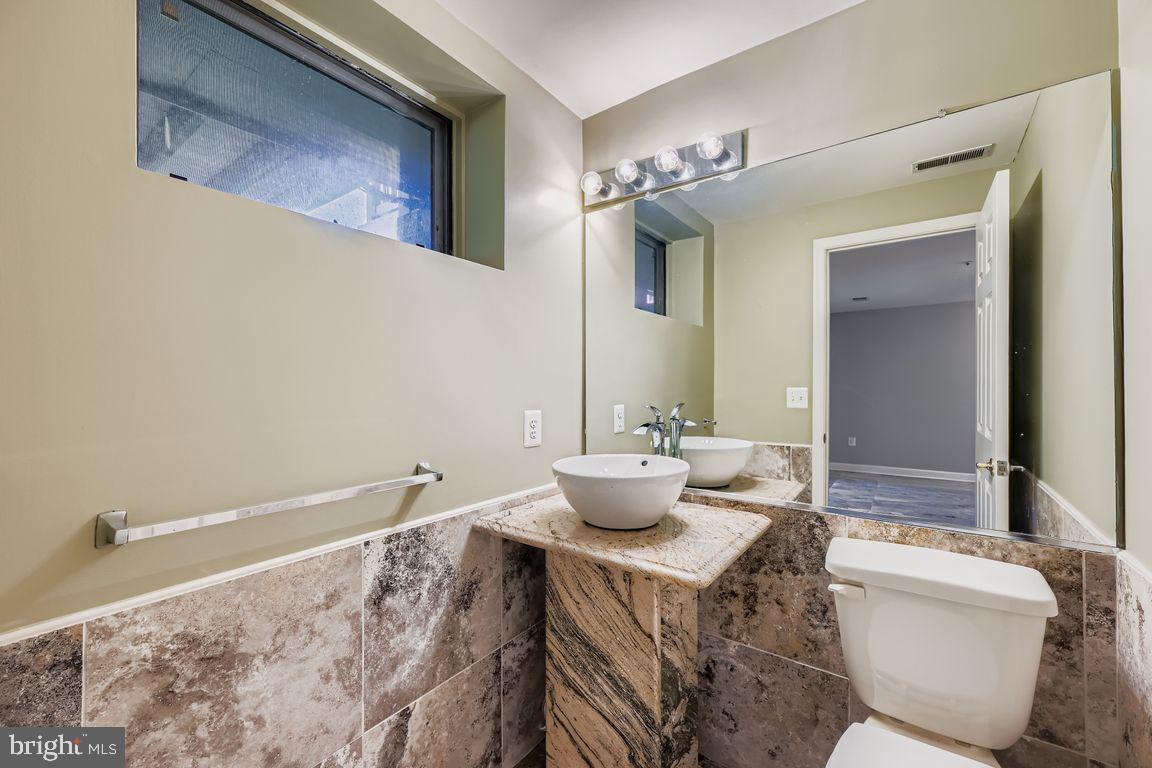 21 Stridesham Court Baltimore, MD 21209 - Photo 18 of 22 a bathroom with a toilet a sink and mirror