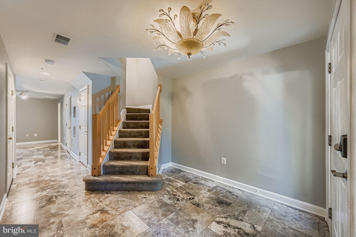 21 Stridesham Court Baltimore, MD 21209 - Photo 19 of 22 a view of a hallway with stairs and wooden floor