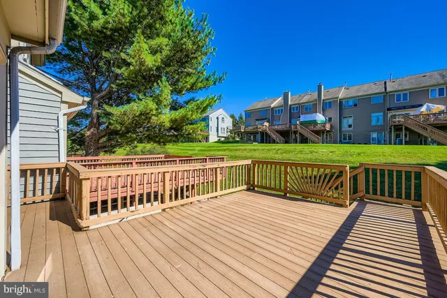 a view of a wooden deck and a yard