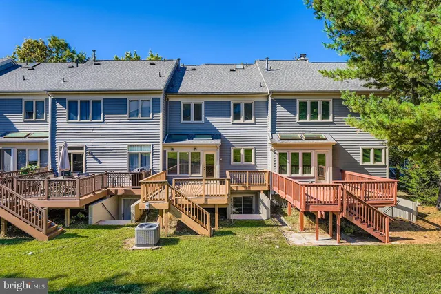 an aerial view of a house with swimming pool and sitting area