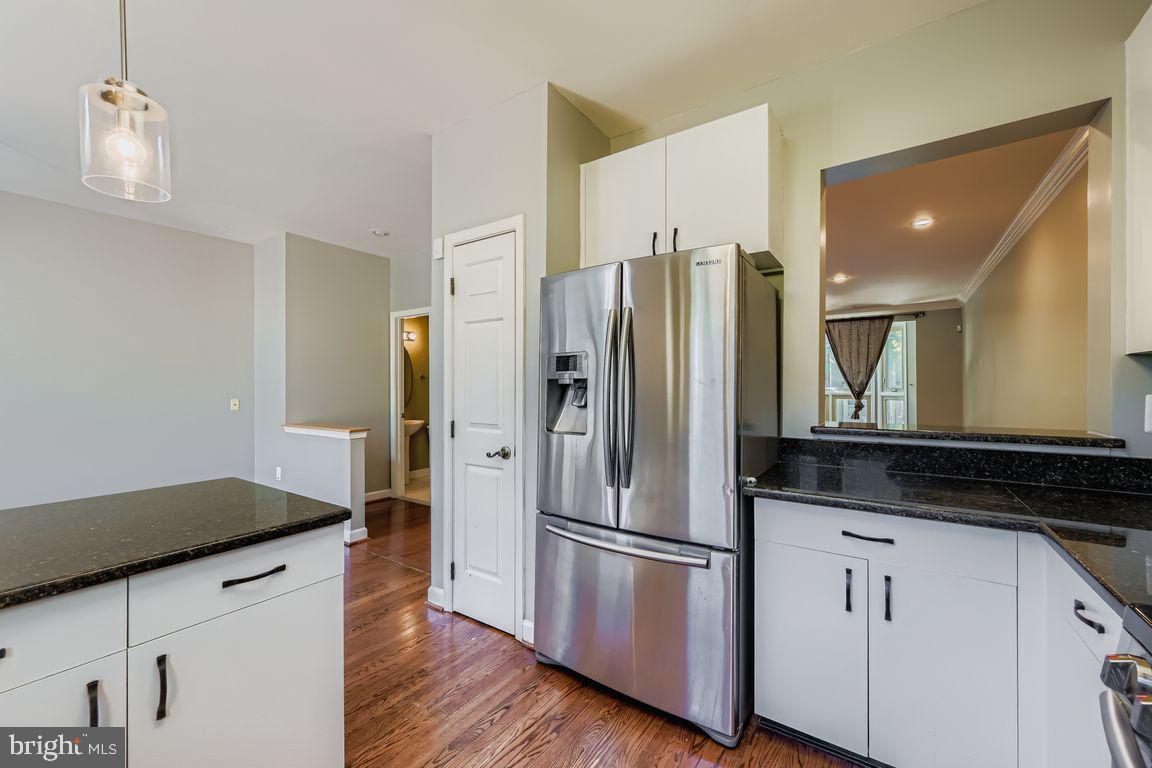 21 Stridesham Court Baltimore, MD 21209 - Photo 3 of 22 a kitchen with stainless steel appliances a refrigerator and wooden floor