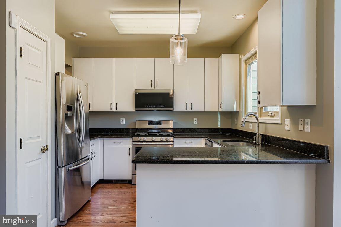 21 Stridesham Court Baltimore, MD 21209 - Photo 4 of 22 a kitchen with stainless steel appliances granite countertop a sink a stove and a refrigerator