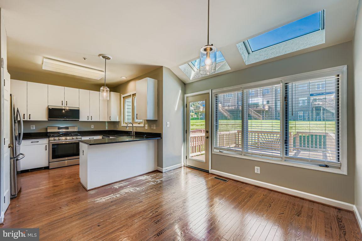 21 Stridesham Court Baltimore, MD 21209 - Photo 5 of 22 a large kitchen with kitchen island a large counter space a sink appliances and cabinets