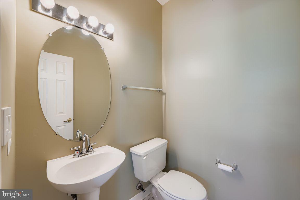 21 Stridesham Court Baltimore, MD 21209 - Photo 8 of 22 a bathroom with a toilet a sink and mirror