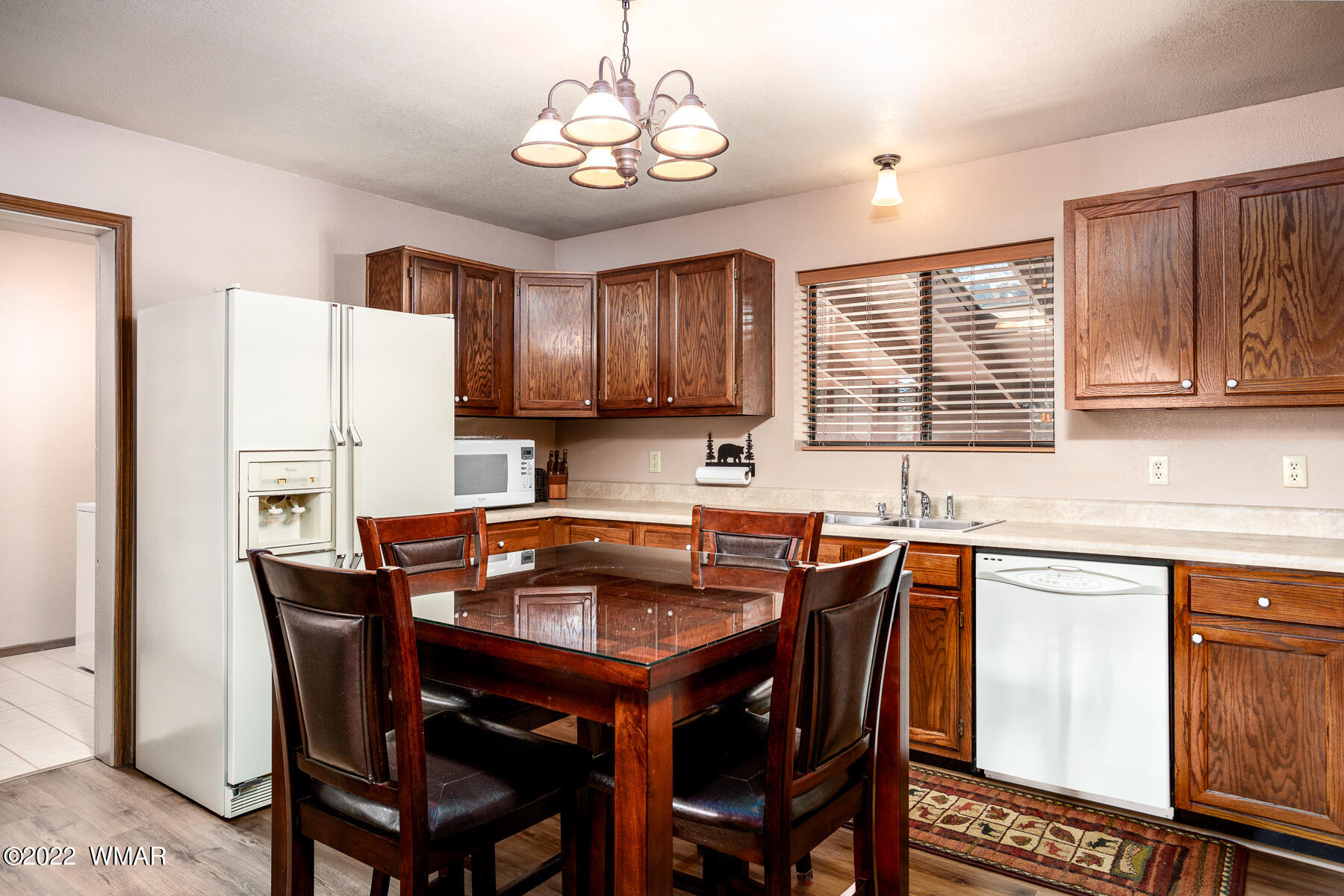 2840 Lodgepole Road Overgaard, AZ 85933 - Photo 13 of 30 a kitchen with stainless steel appliances granite countertop a dining table chairs refrigerator and cabinets