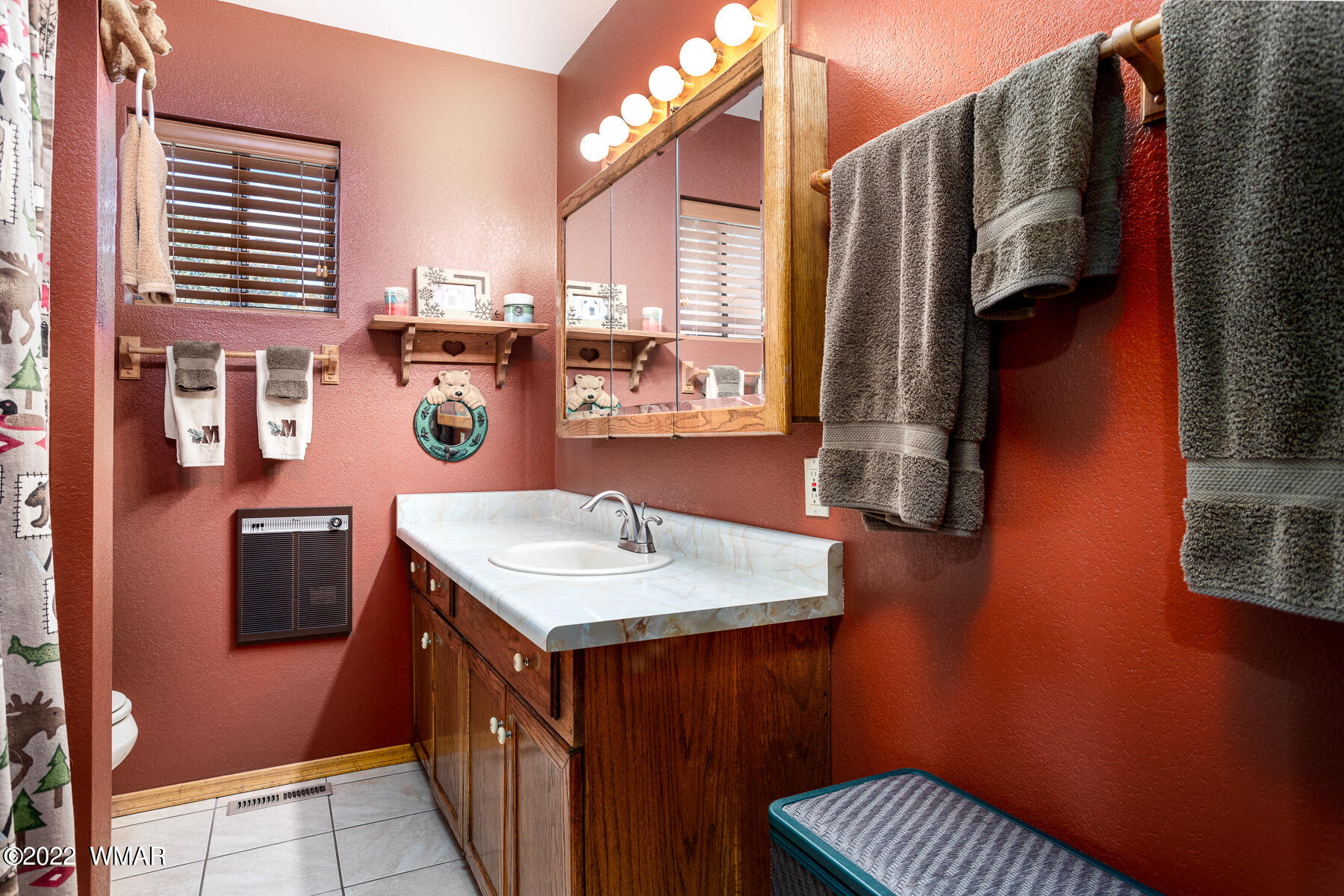 2840 Lodgepole Road Overgaard, AZ 85933 - Photo 16 of 30 a bathroom with a sink a mirror and a window