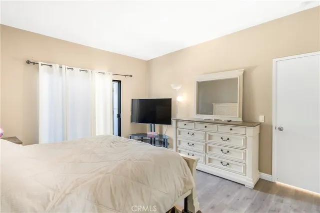 a bedroom with a bed and a television