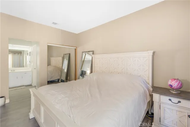 a bedroom with a bed and a dresser