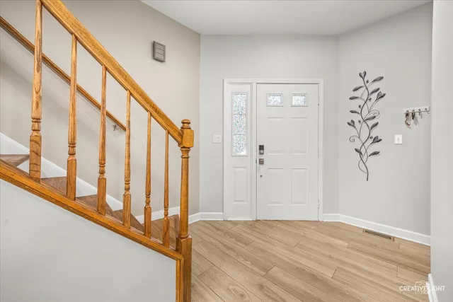 a view of an entryway with wooden floor