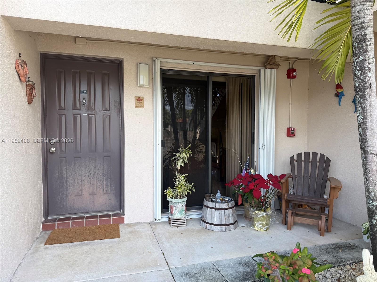 351 Club Circle, Unit 102 Boca Raton, FL 33487 - Photo 2 of 34 a front view of a house with outdoor seating