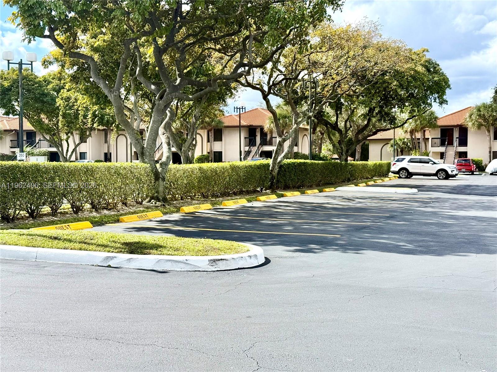 351 Club Circle, Unit 102 Boca Raton, FL 33487 - Photo 3 of 34 a view of road with house and trees in the background
