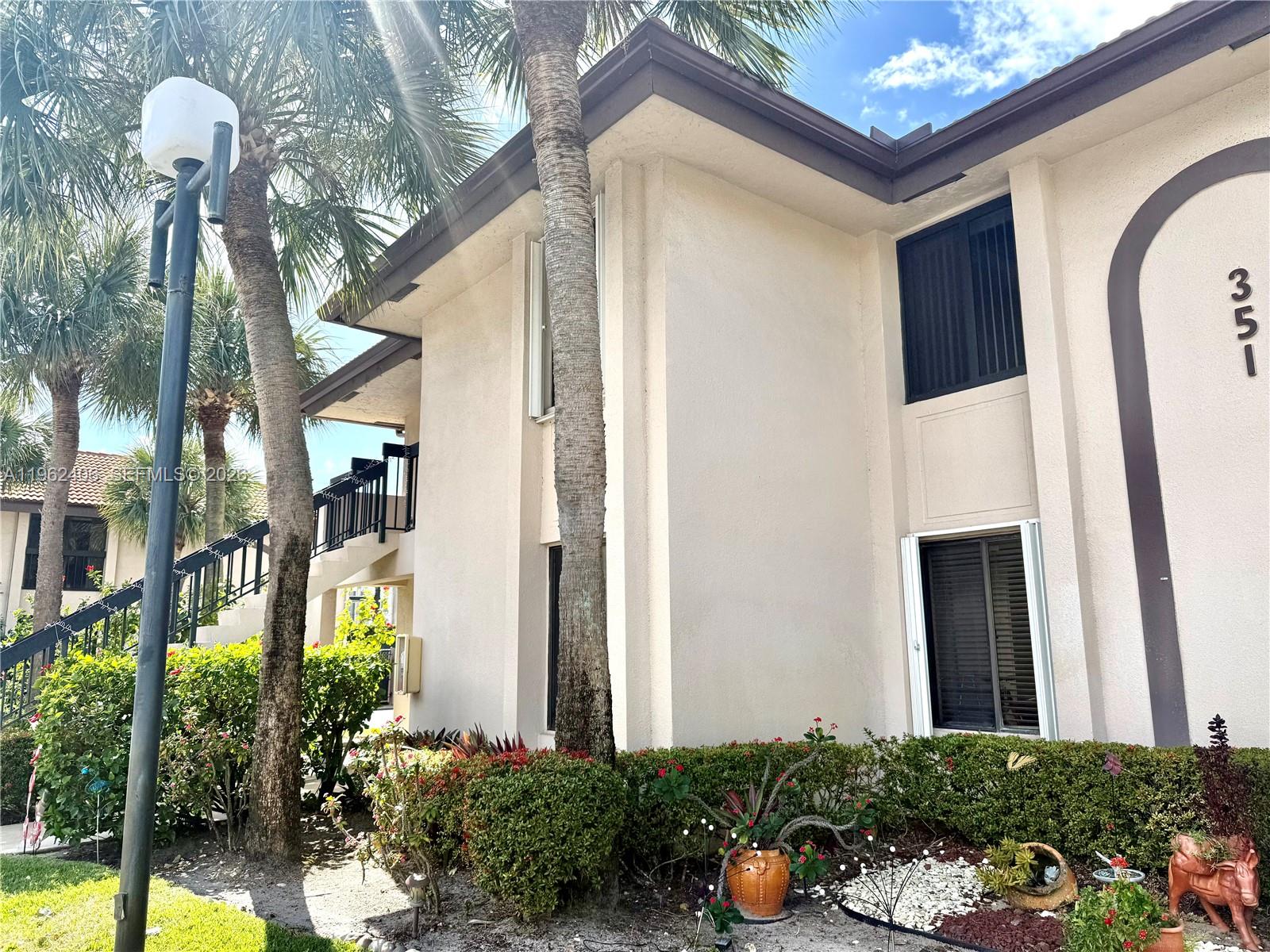 351 Club Circle, Unit 102 Boca Raton, FL 33487 - Photo 5 of 34 a view of a house with a flower garden