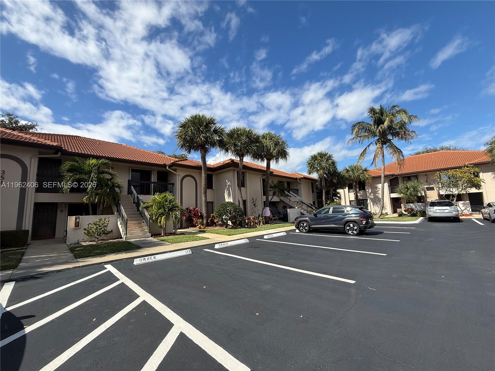 351 Club Circle, Unit 102 Boca Raton, FL 33487 - Photo 6 of 34 a couple of cars parked in front of a building