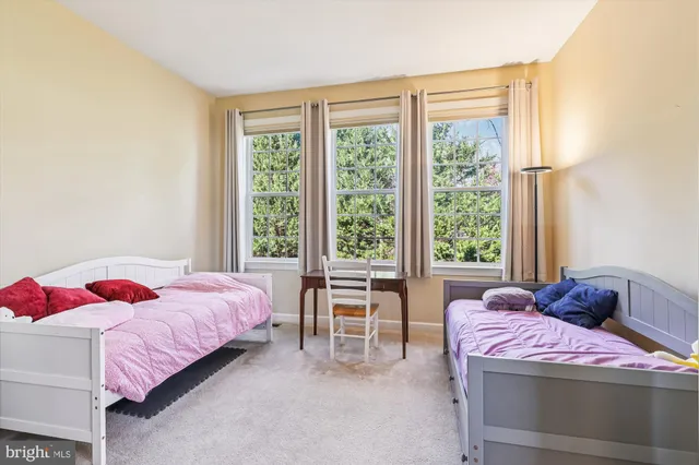 a bedroom with a bed and a large window