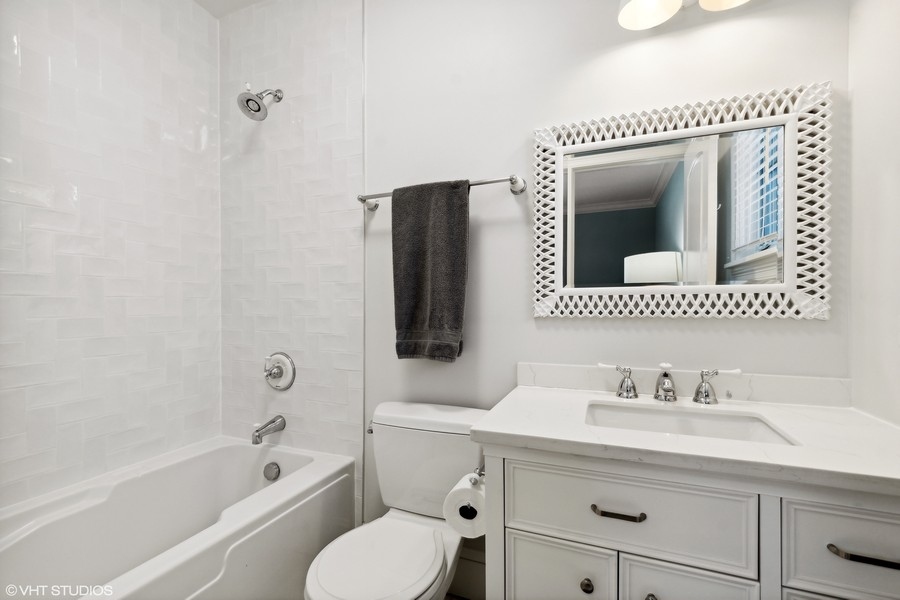 544 Sterling Road Kenilworth, IL 60043 - Photo 14 of 30 a bathroom with a granite countertop sink mirror vanity and bathtub