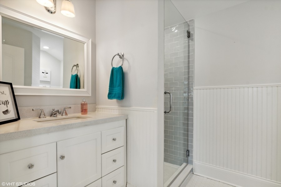 544 Sterling Road Kenilworth, IL 60043 - Photo 16 of 30 a bathroom with a double vanity sink and mirror