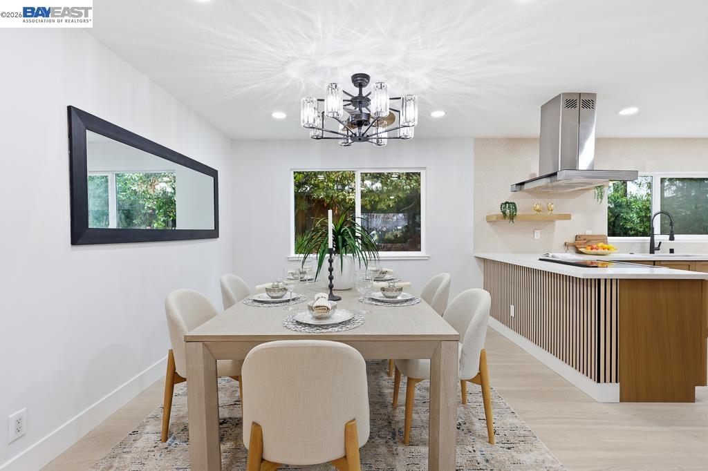 74 Hazelnut Court San Ramon, CA 94583 - Photo 12 of 60 a dining room with wooden floor a chandelier a wooden table and chairs