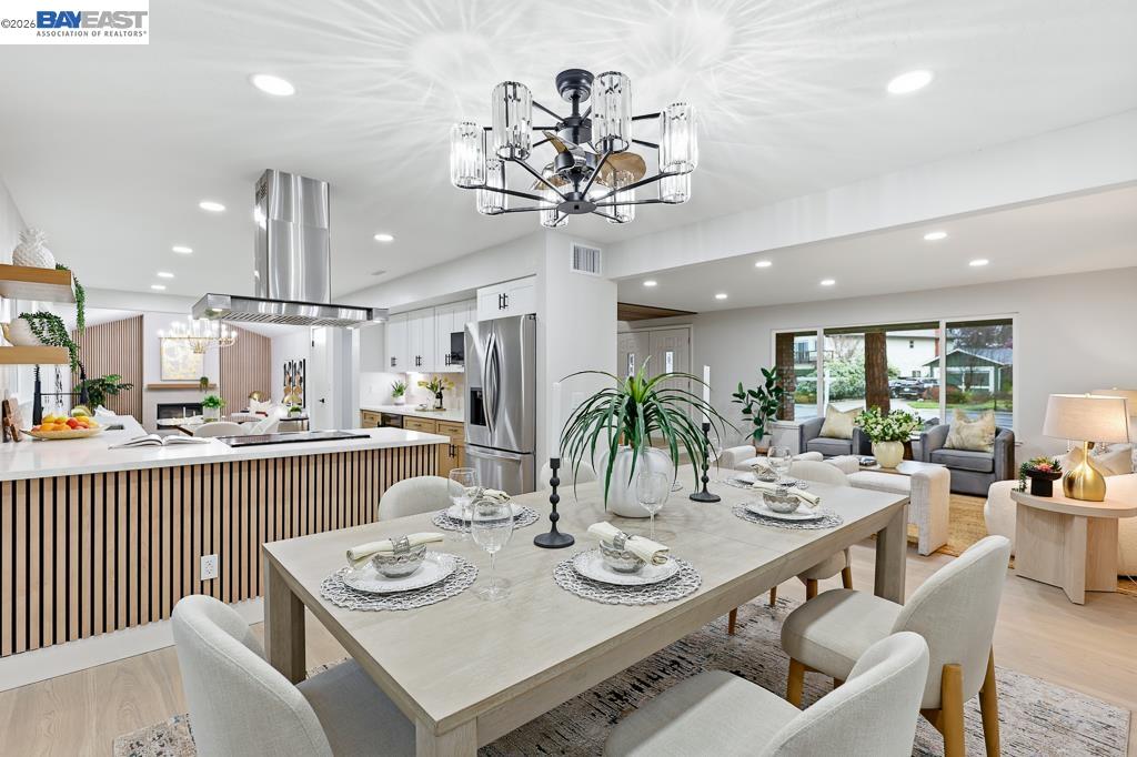 74 Hazelnut Court San Ramon, CA 94583 - Photo 13 of 60 a view of a dining room with furniture a kitchen and chandelier
