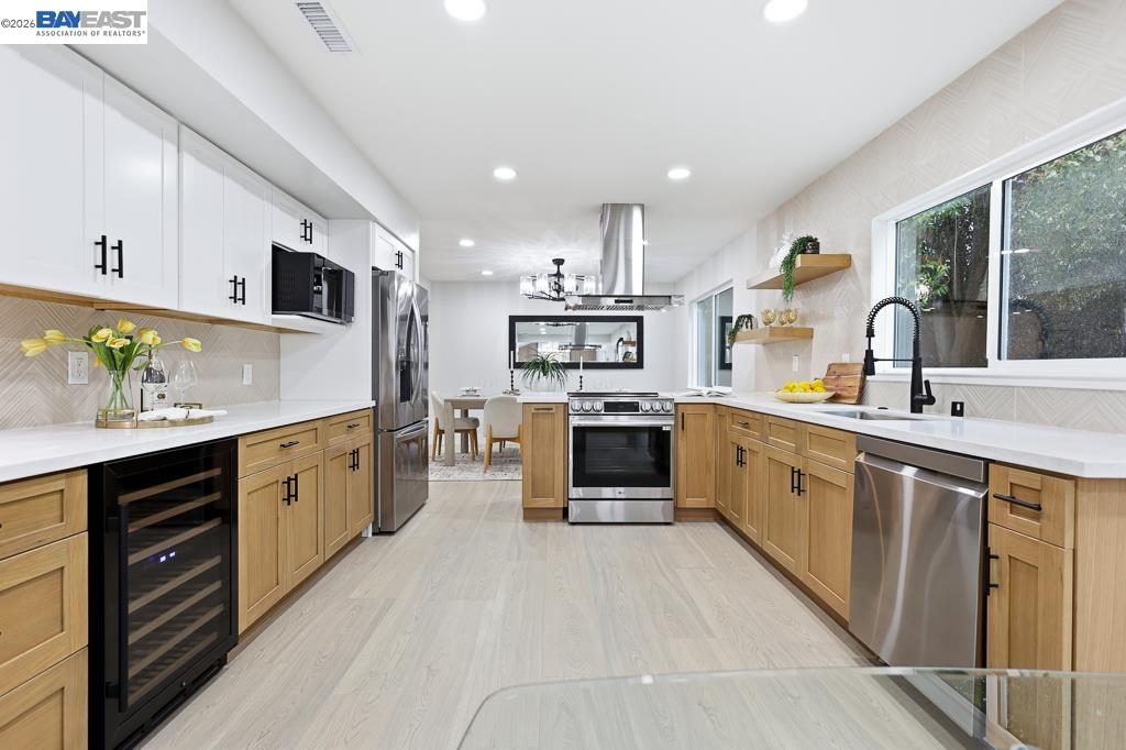 74 Hazelnut Court San Ramon, CA 94583 - Photo 19 of 60 a large kitchen with stainless steel appliances kitchen island granite countertop a sink and cabinets