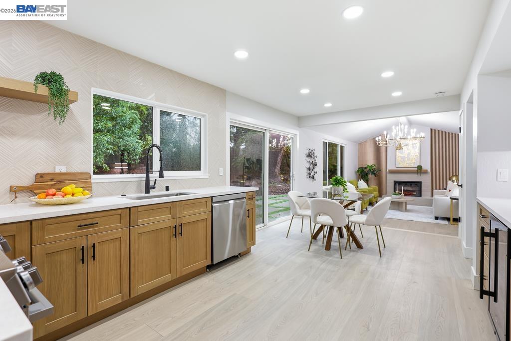 74 Hazelnut Court San Ramon, CA 94583 - Photo 22 of 60 a large living room with stainless steel appliances granite countertop furniture a fireplace and a large window