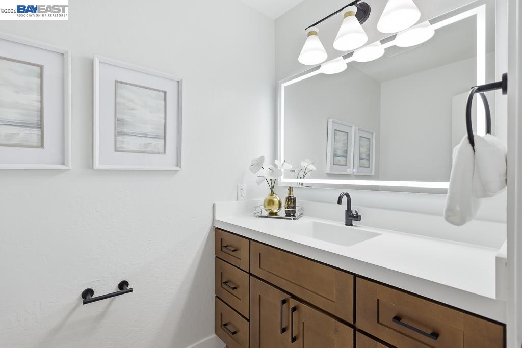 74 Hazelnut Court San Ramon, CA 94583 - Photo 28 of 60 a bathroom with a sink vanity and a mirror