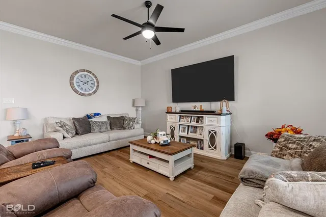 a kitchen with a refrigerator a sink and wooden floor