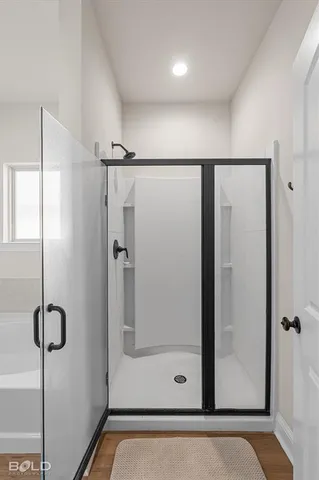a en suite bathroom with a granite countertop sink and mirror