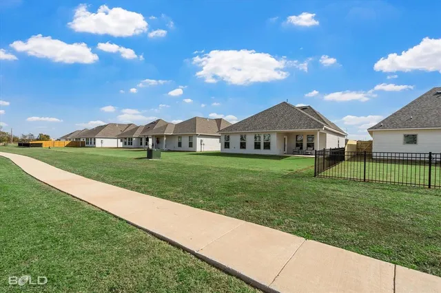 a bathroom with a granite countertop toilet sink and mirror