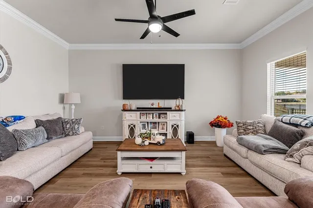a living room with furniture kitchen view and a window