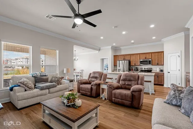 a living room with furniture flat screen tv and wooden floor