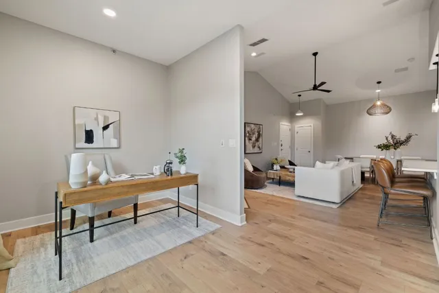 a living room with furniture and a wooden floor