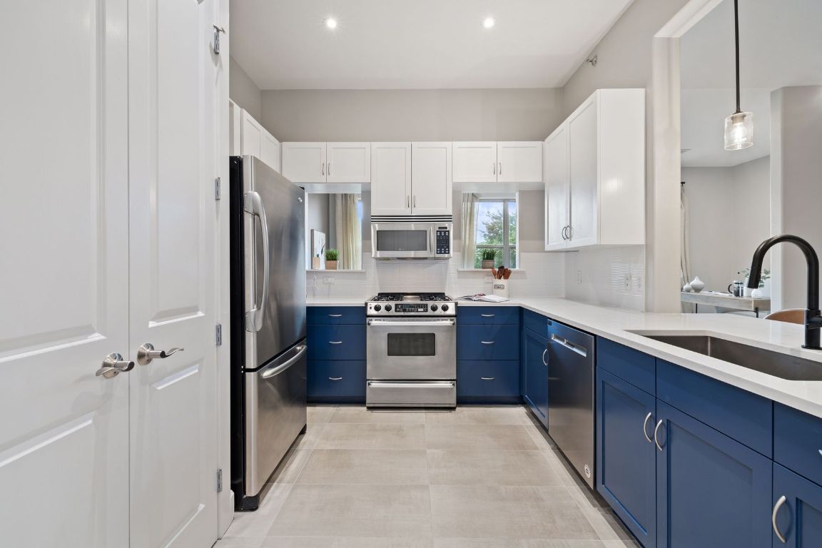 2216 Thornton Road, Unit 431 Austin, TX 78704 - Photo 12 of 30 a kitchen with stainless steel appliances granite countertop a stove a sink and a refrigerator