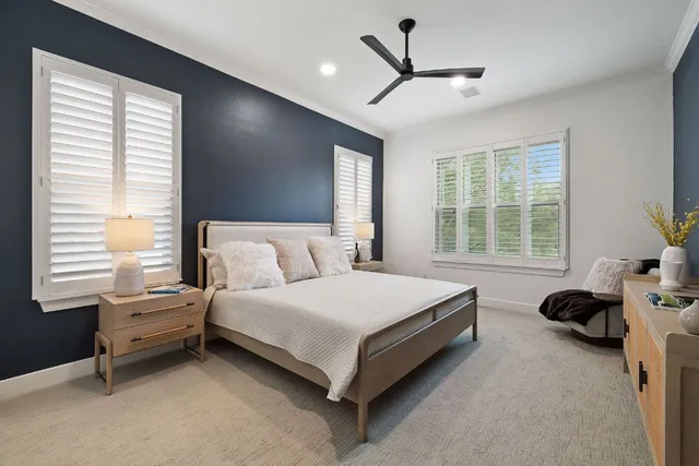 a spacious bedroom with a bed and a window