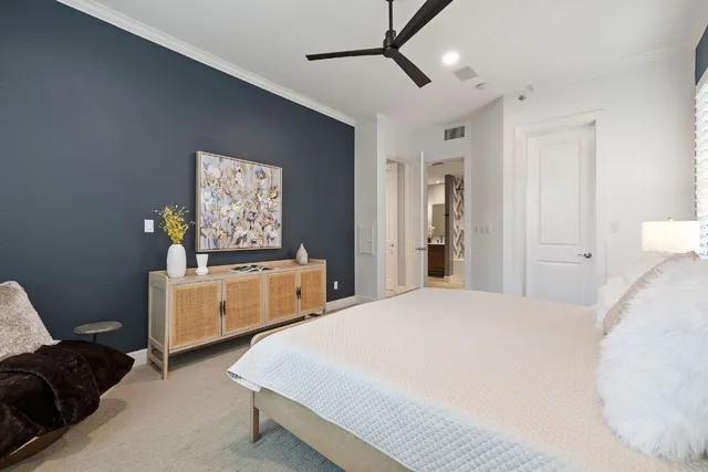 a bedroom with a bed and a dresser