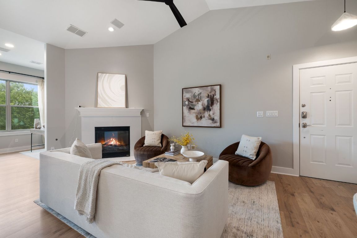 2216 Thornton Road, Unit 431 Austin, TX 78704 - Photo 2 of 30 a living room with furniture and a fireplace