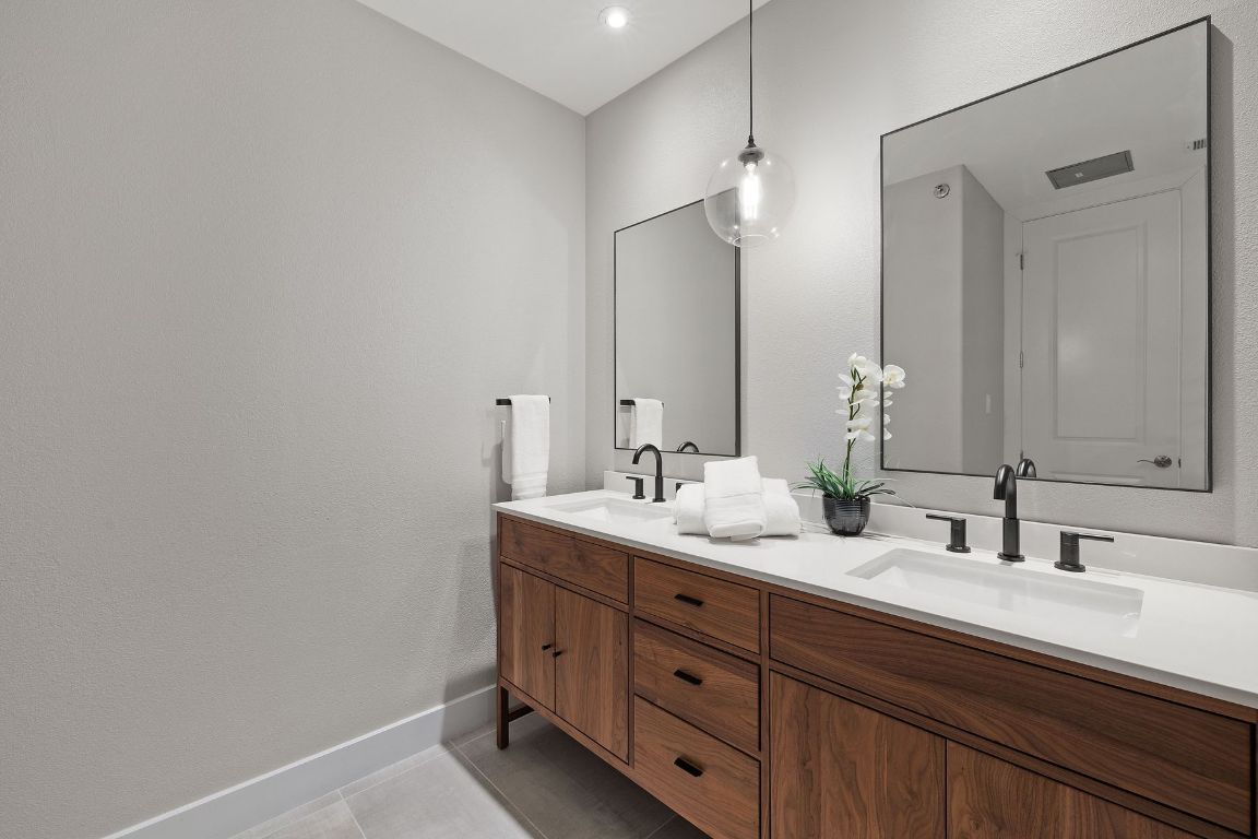 2216 Thornton Road, Unit 431 Austin, TX 78704 - Photo 21 of 30 a bathroom with double sink and a mirror