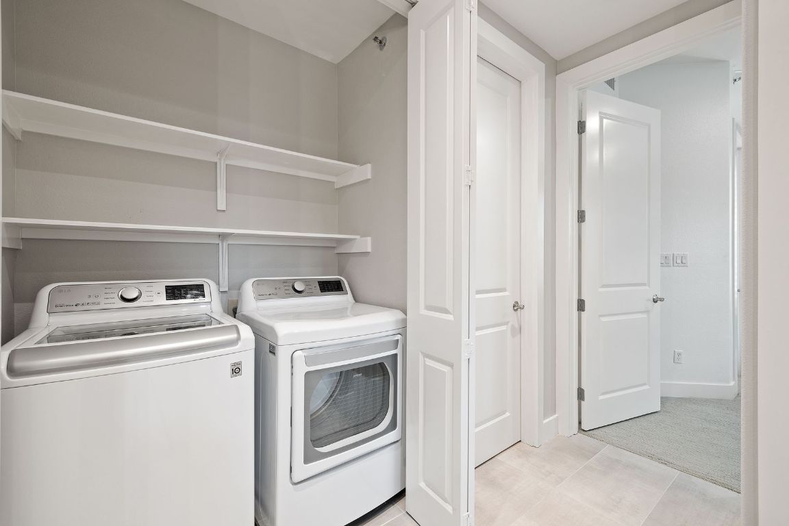 2216 Thornton Road, Unit 431 Austin, TX 78704 - Photo 23 of 30 a view of washer and dryer with kitchen in the background