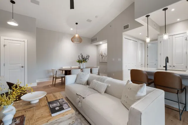 a living room with furniture and a chandelier