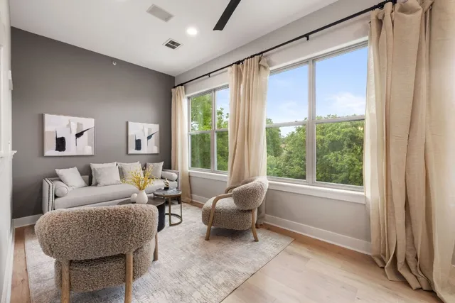 a living room with furniture and a large window