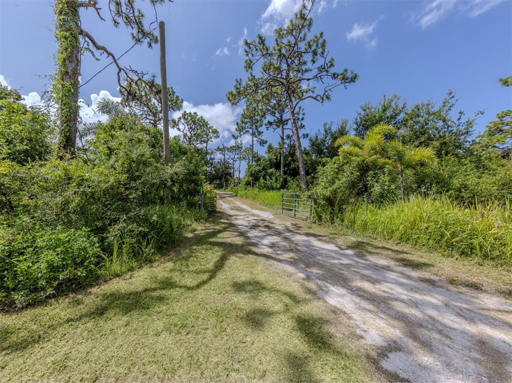 East Manasota Beach Road Englewood, FL 34223 - Photo 25 of 65 a view of a yard with plants and a trees