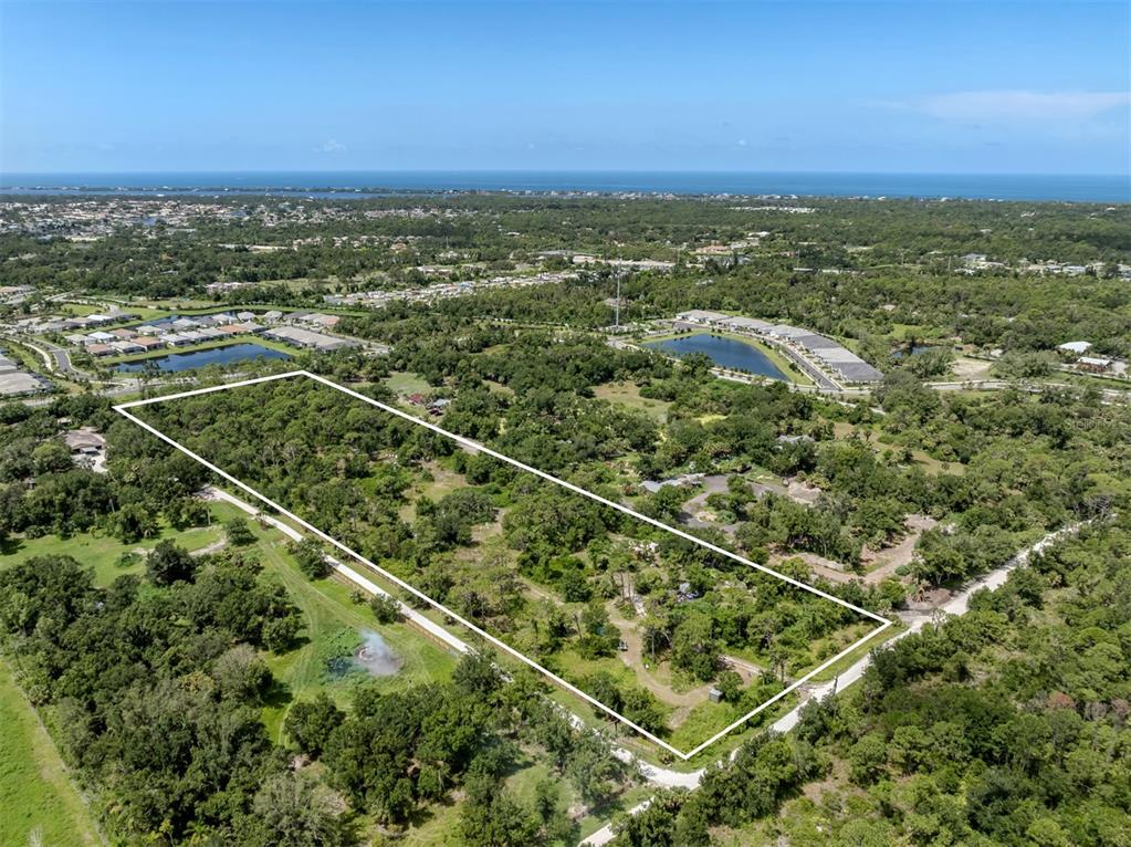 East Manasota Beach Road Englewood, FL 34223 - Photo 4 of 65 an aerial view of residential houses with outdoor space and trees