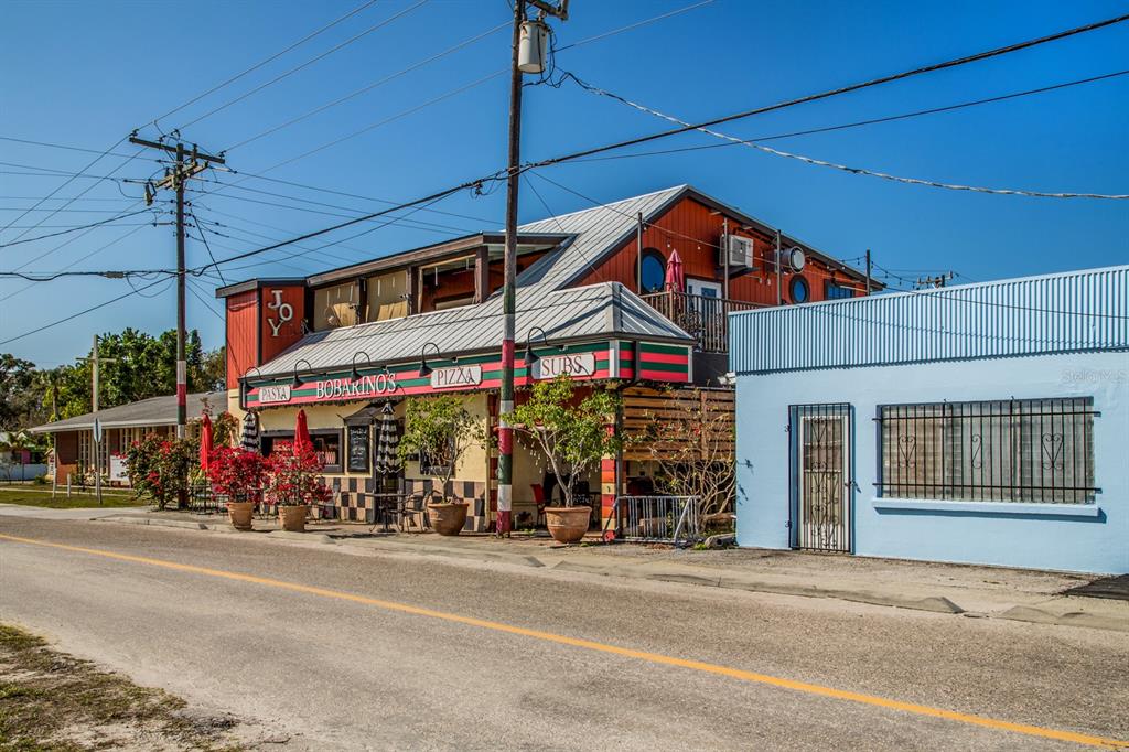 East Manasota Beach Road Englewood, FL 34223 - Photo 52 of 65 a group of people sitting on a street in front of a building